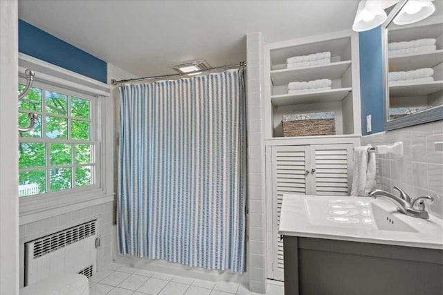 57 Highland St, Holden, MA 01520 - bathroom with radiator, vanity, tile patterned flooring, tile walls, and a shower with curtain
