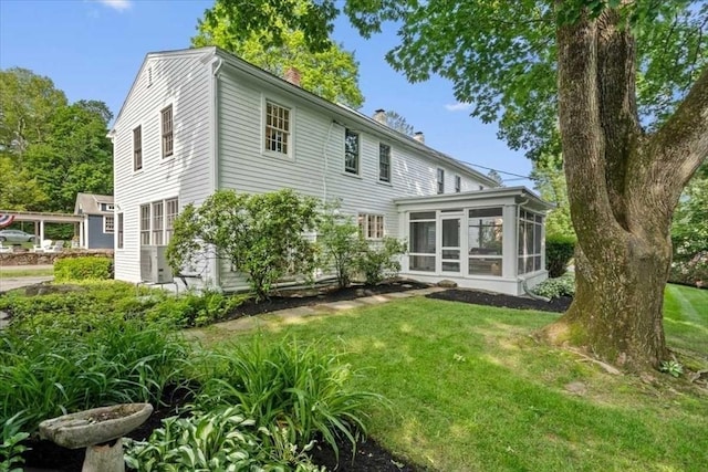 57 Highland St, Holden, MA 01520 - back of property featuring a chimney, a sunroom, and a lawn