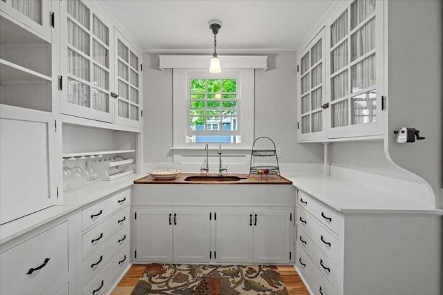 57 Highland St, Holden, MA 01520 - kitchen with a sink, light wood-type flooring, white cabinets, and glass insert cabinets