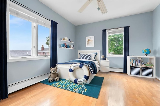 80 Lennox Rd Unit 1, Nahant, MA 01908 - bedroom featuring wood finished floors, a baseboard radiator, and a ceiling fan
