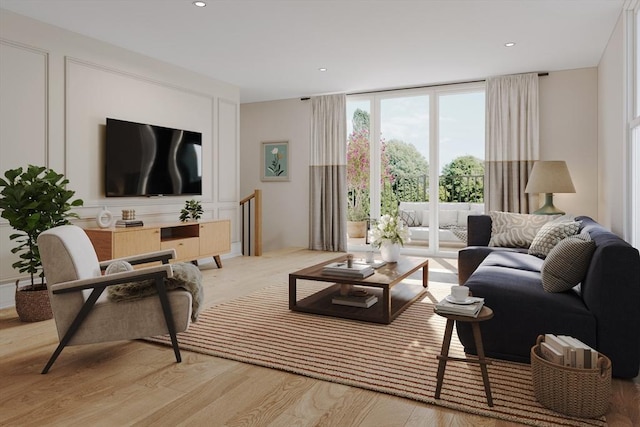 living room with light wood-type flooring and expansive windows