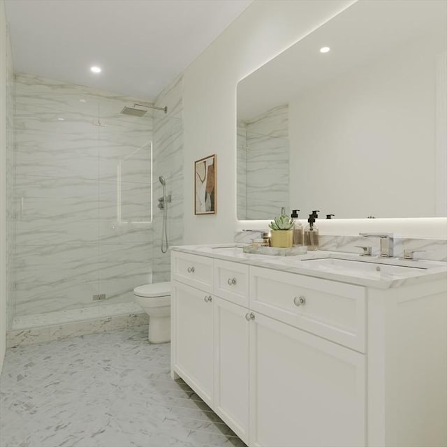 bathroom with a tile shower, vanity, and toilet