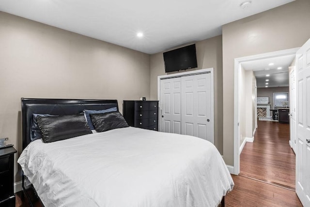 bedroom featuring a closet and dark hardwood / wood-style flooring