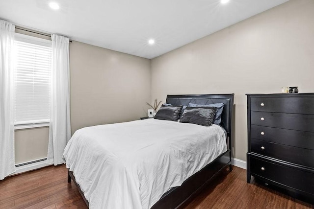 bedroom featuring a baseboard radiator and dark wood-type flooring