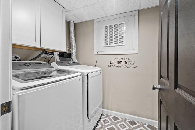 laundry room featuring cabinets and washing machine and clothes dryer