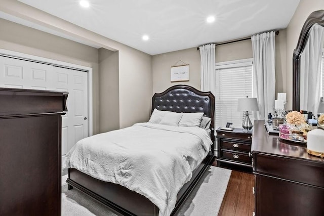 bedroom with dark hardwood / wood-style flooring