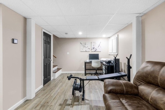 office with a drop ceiling and light wood-type flooring