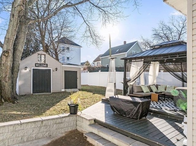 view of yard with a gazebo, a wooden deck, and a shed