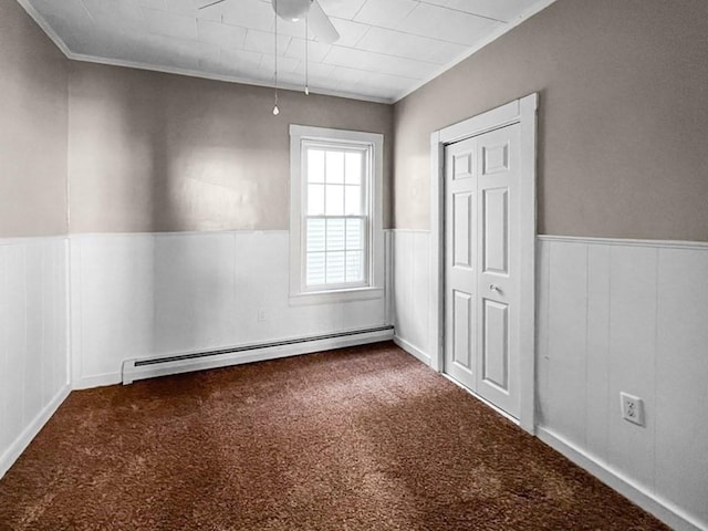 carpeted spare room with crown molding, a baseboard radiator, and ceiling fan