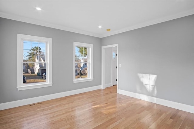 empty room featuring light hardwood / wood-style floors and ornamental molding