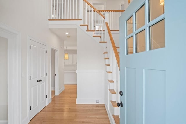 entryway with wood-type flooring and a high ceiling