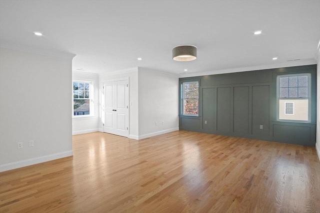 interior space with light wood-type flooring and ornamental molding