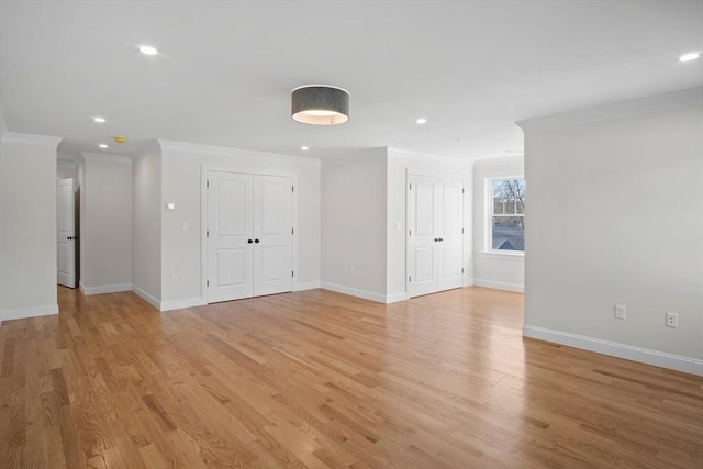 spare room with light wood-type flooring and crown molding