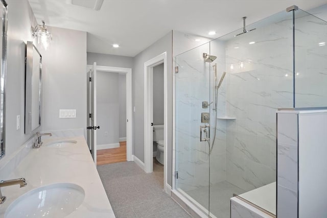 bathroom featuring vanity, toilet, and walk in shower