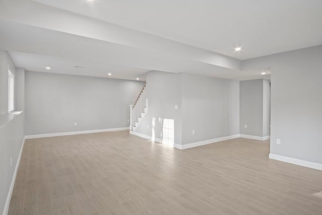 basement with light hardwood / wood-style flooring