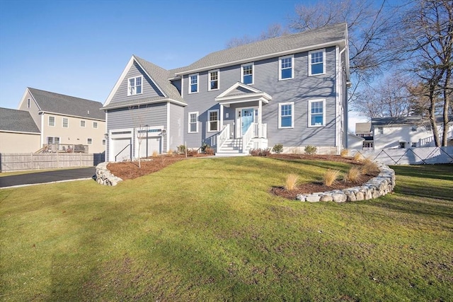 view of front of property with a garage and a front lawn