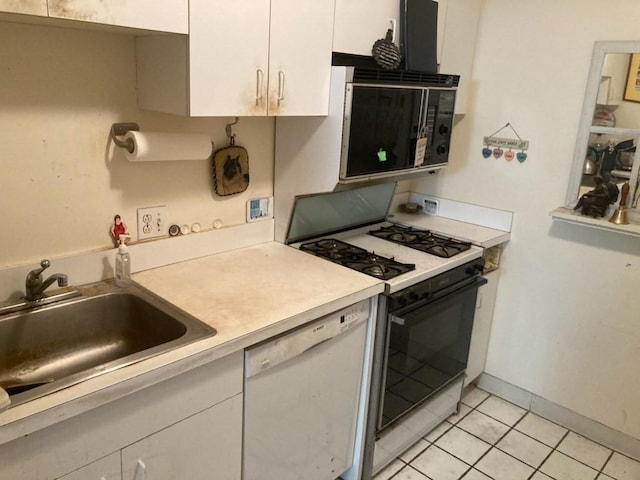 kitchen featuring light tile patterned flooring, sink, white dishwasher, range with gas stovetop, and white cabinets