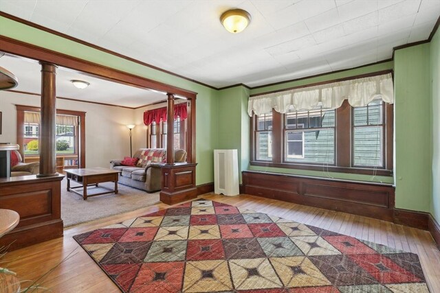 26 W Walnut St, Milford, MA 01757 - living area featuring crown molding, wood-type flooring, and decorative columns