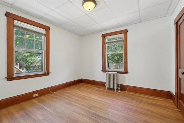 26 W Walnut St, Milford, MA 01757 - unfurnished room featuring light wood finished floors, radiator, baseboards, and a healthy amount of sunlight