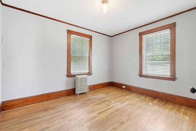 26 W Walnut St, Milford, MA 01757 - empty room featuring baseboards, radiator, hardwood / wood-style floors, and crown molding
