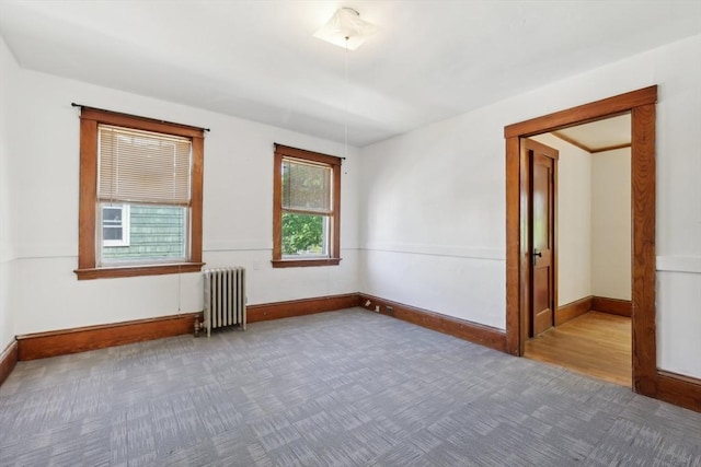 26 W Walnut St, Milford, MA 01757 - unfurnished room featuring baseboards, radiator heating unit, and carpet floors