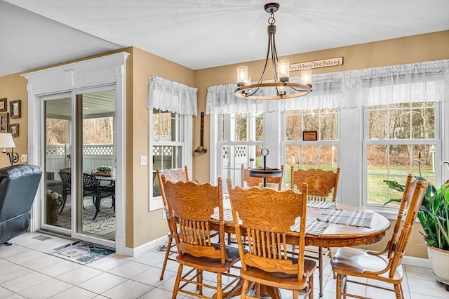 tiled dining space featuring a chandelier