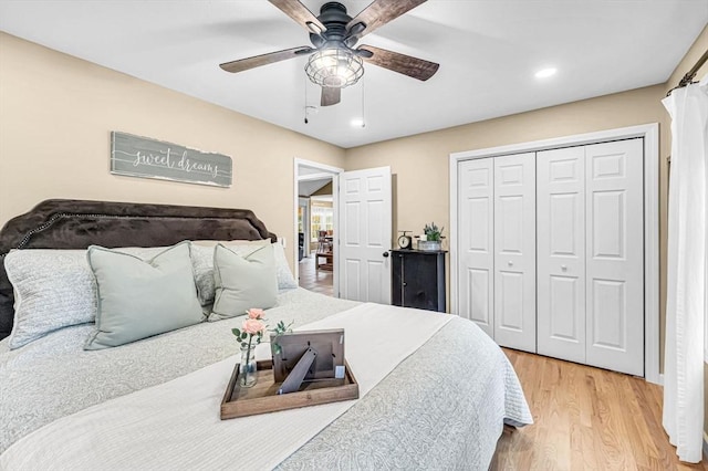 bedroom with ceiling fan, light hardwood / wood-style flooring, and a closet