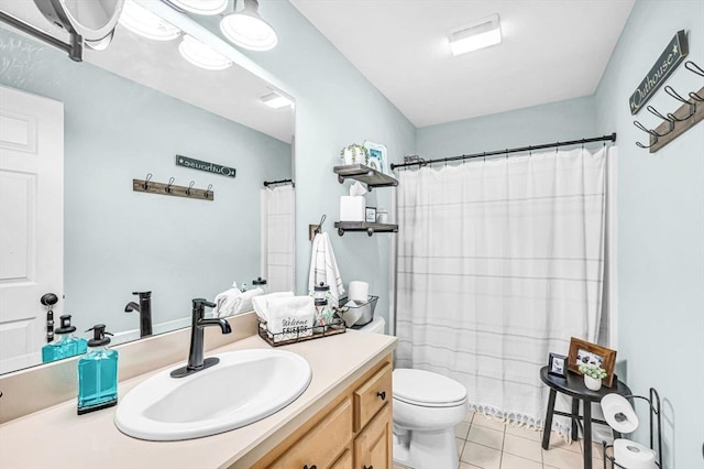 bathroom featuring toilet, vanity, tile patterned floors, and walk in shower