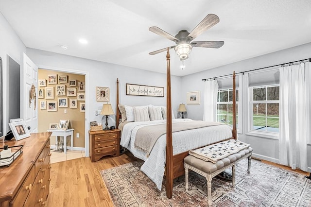 bedroom with ceiling fan and light hardwood / wood-style flooring