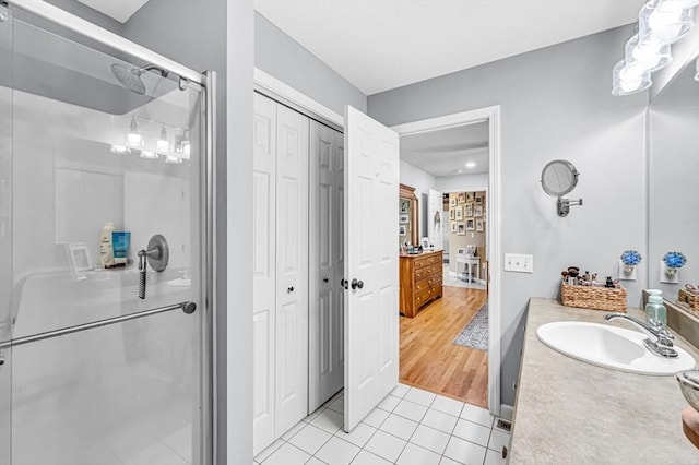 bathroom with vanity, tile patterned floors, and a shower with shower door