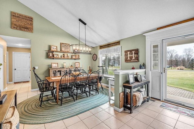 dining space featuring lofted ceiling, light tile patterned flooring, and plenty of natural light