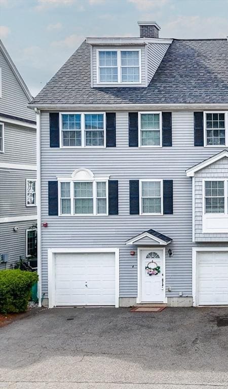 14 Watson St Unit 4, Lowell, MA 01852 - view of front facade with a garage, a chimney, roof with shingles, and asphalt driveway