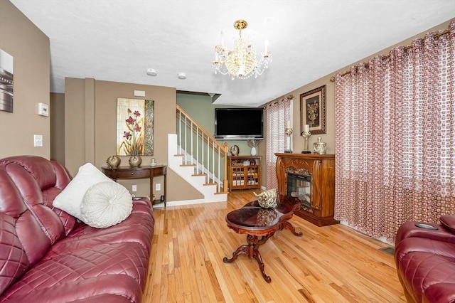 14 Watson St Unit 4, Lowell, MA 01852 - living area with wood finished floors, a chandelier, stairs, and a high end fireplace
