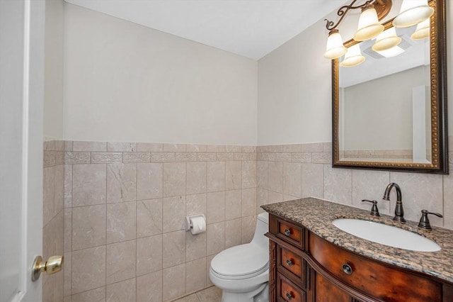 14 Watson St Unit 4, Lowell, MA 01852 - bathroom featuring vanity, tile walls, and a wainscoted wall
