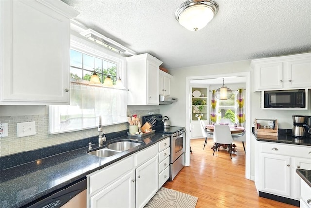 2480 Wilbraham Rd, Springfield, MA 01129 - kitchen with stainless steel appliances, under cabinet range hood, a sink, dark countertops, and a textured ceiling