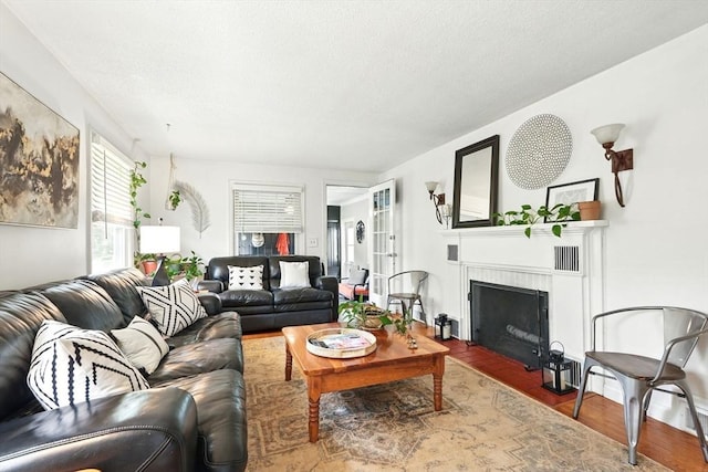 2480 Wilbraham Rd, Springfield, MA 01129 - living area featuring a fireplace with flush hearth and wood finished floors