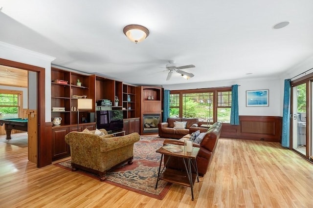 32 Witham St Unit B, Gloucester, MA 01930 - living area with light wood-type flooring, pool table, a glass covered fireplace, healthy amount of natural light, and ornamental molding