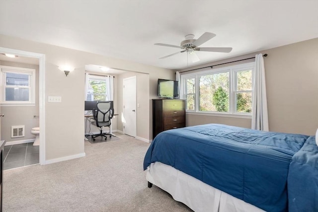 carpeted bedroom with a ceiling fan, baseboards, visible vents, and ensuite bathroom
