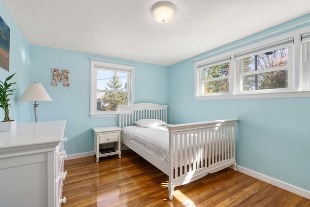 bedroom featuring baseboards and wood finished floors