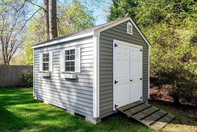 view of shed featuring fence