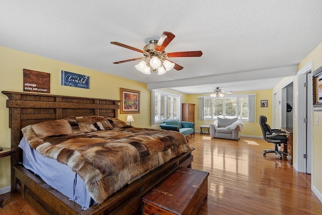 407 Mountain Rd, Jaffrey, NH 03452 - bedroom with baseboards, a textured ceiling, ceiling fan, and wood finished floors