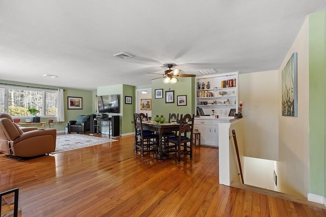 407 Mountain Rd, Jaffrey, NH 03452 - dining room featuring light wood finished floors, baseboards, visible vents, and ceiling fan