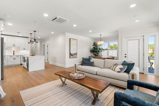 18 Franklin Unit 303A, Salem, MA 01970 - living area featuring ornamental molding, baseboards, recessed lighting, and light wood-style floors