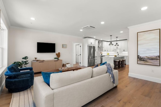 18 Franklin Unit 303A, Salem, MA 01970 - living area featuring ornamental molding, recessed lighting, baseboards, and light wood-style floors
