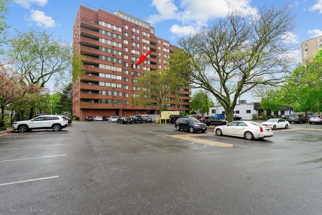 view of building exterior with uncovered parking