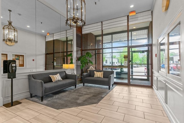 common area featuring a high ceiling, a decorative wall, and recessed lighting