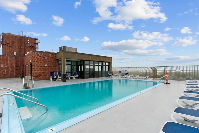 community pool featuring fence and a patio