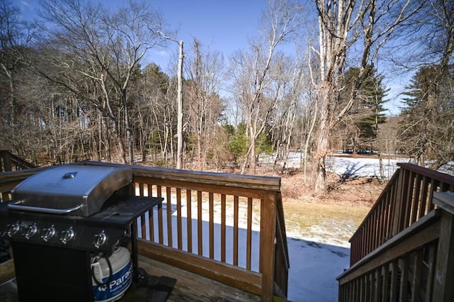 wooden deck with a grill