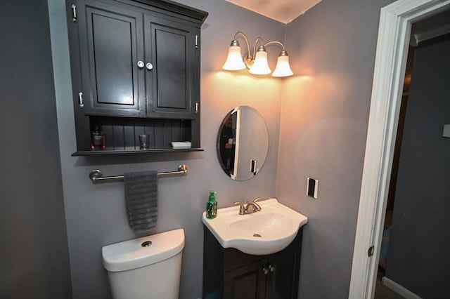 half bathroom featuring toilet and vanity