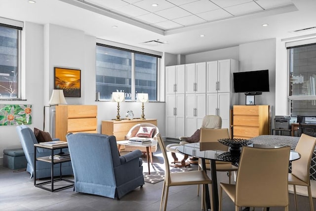 interior space featuring a raised ceiling and recessed lighting